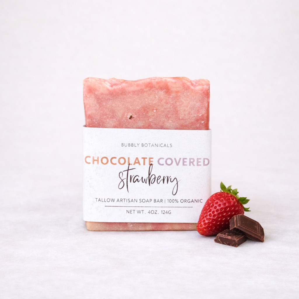 Bar of grass-fed tallow soap labeled 'Chocolate Covered Strawberry' with a strawberry and chocolate pieces on a white background
