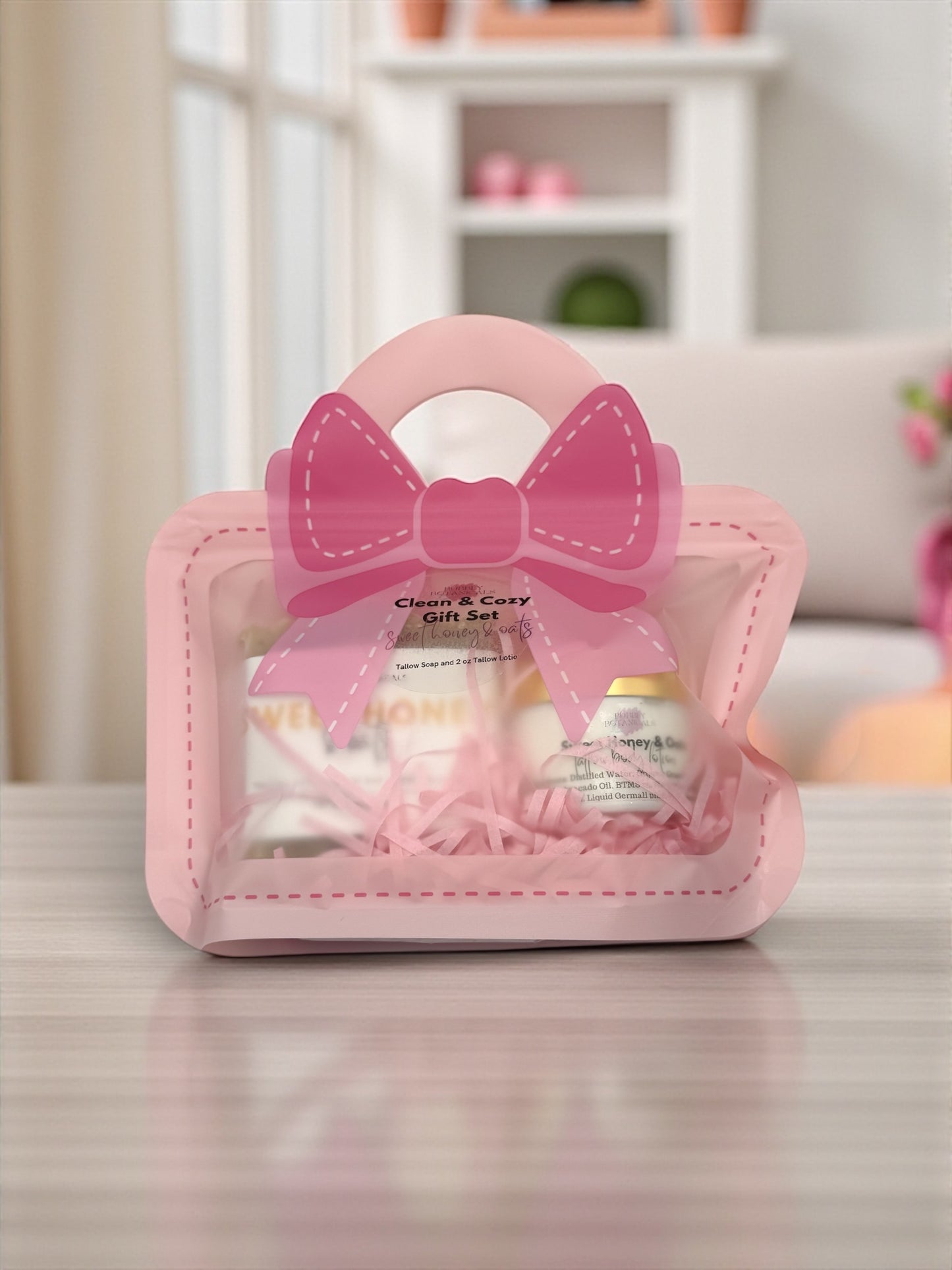 Pink gift set with a bow on a table