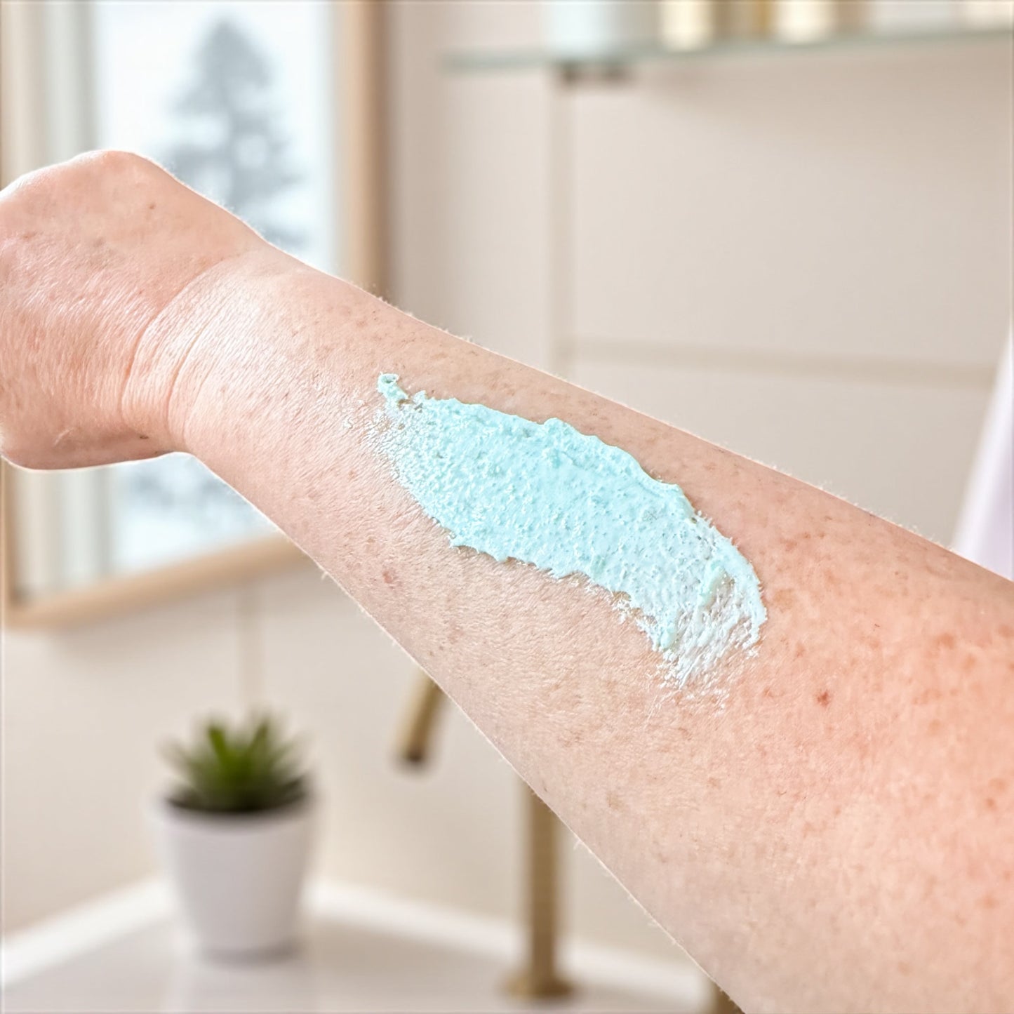 Person's arm with a blue scrub application in a bathroom setting