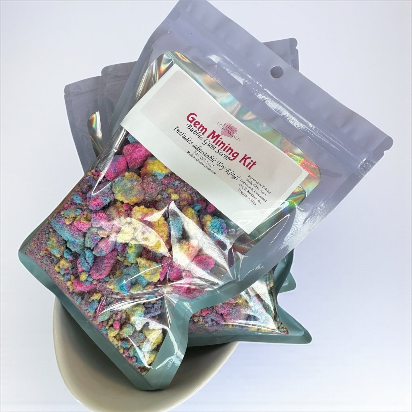 Colorful gem mining kit with a star-shaped container on a white background