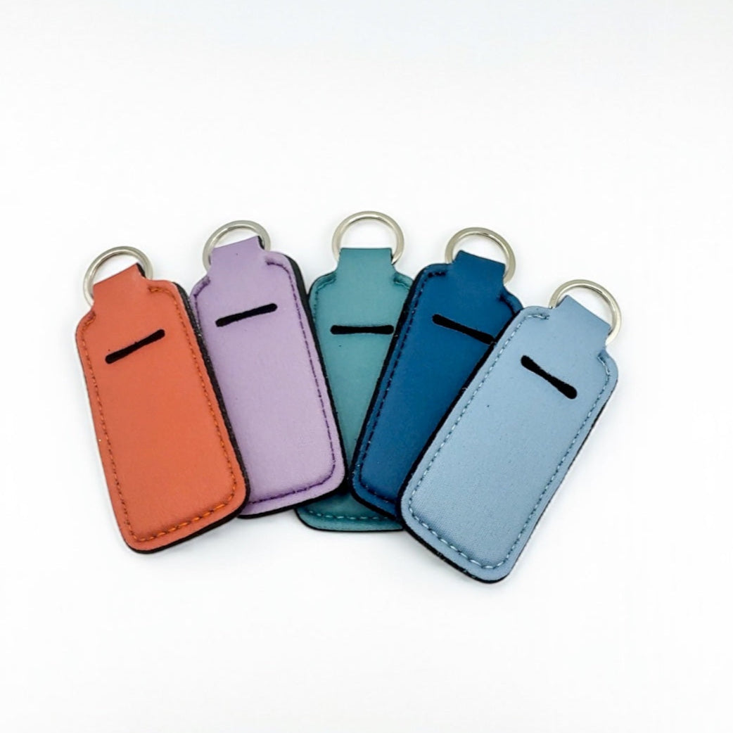 Five colorful keychains on a white background