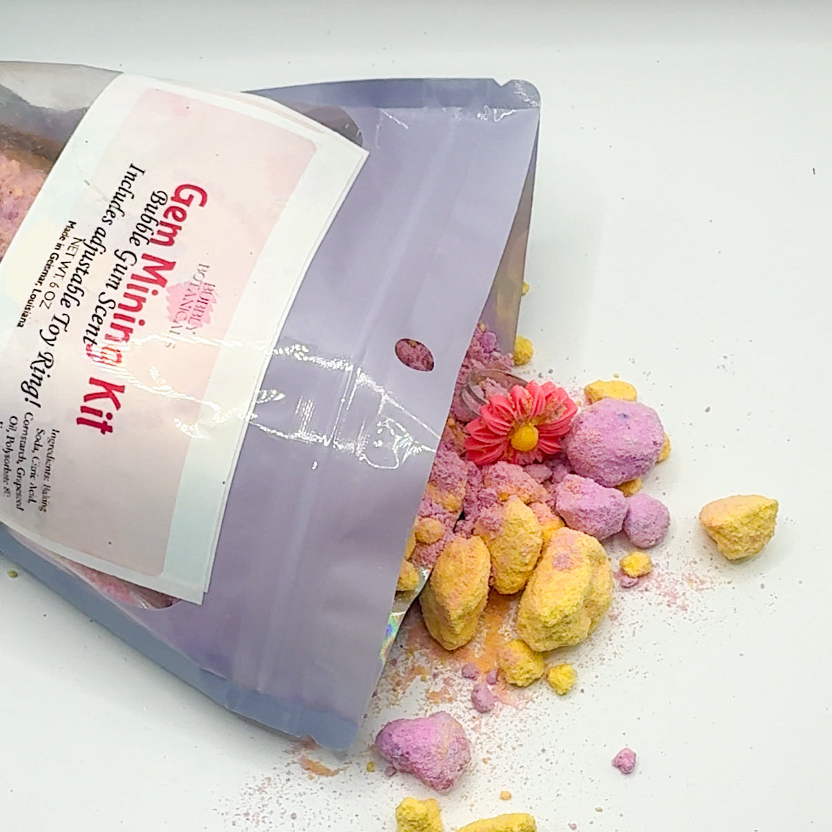 Color mixing kit with colorful powders spilling out on a white surface