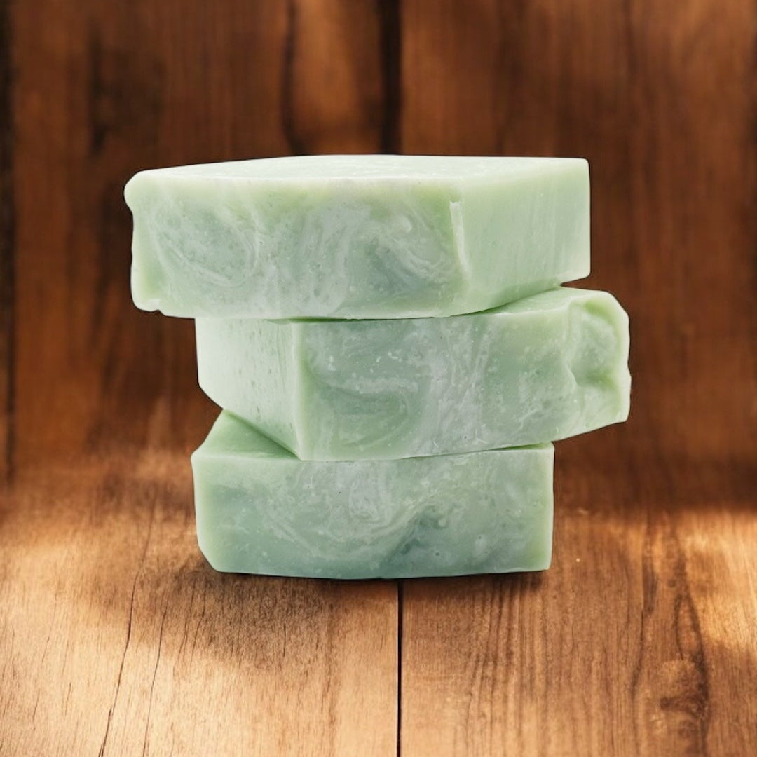 Stack of green soap bars on a wooden surface