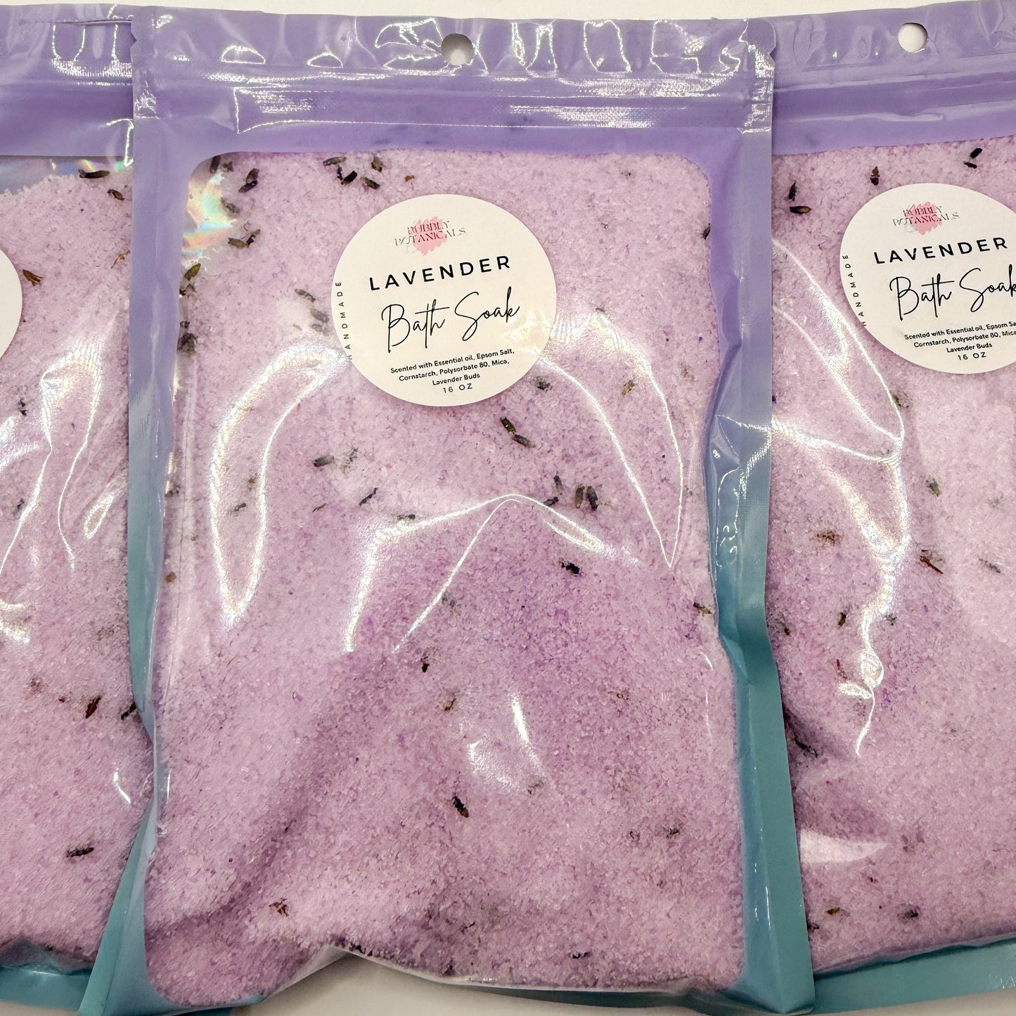 Three packages of lavender bath soaks on a white background