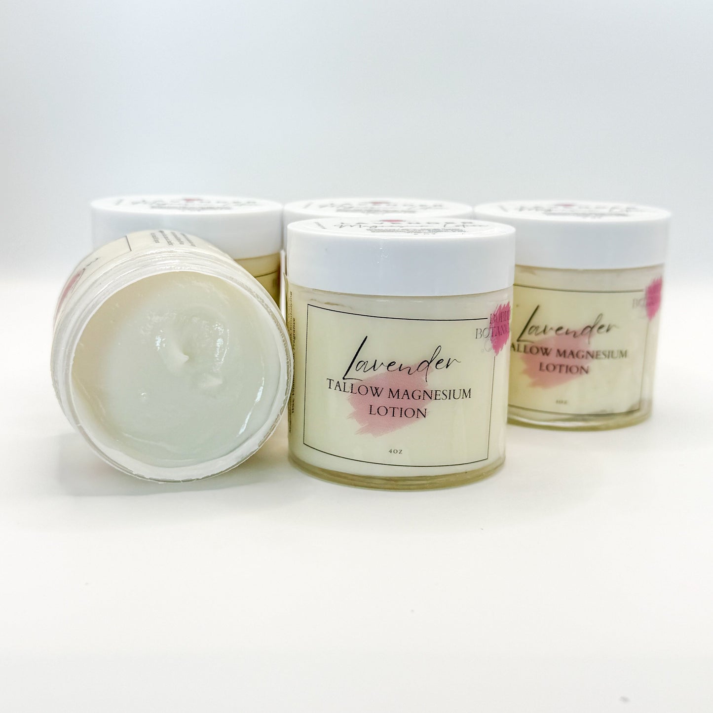 Three jars of lavender tallow magnesium lotion on a white background