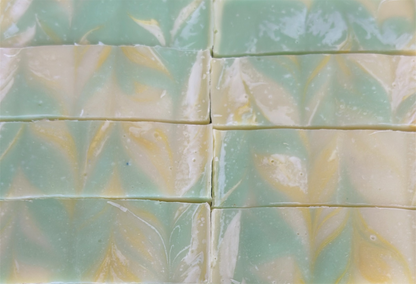 Green and yellow marbled soap bars arranged in a grid pattern.