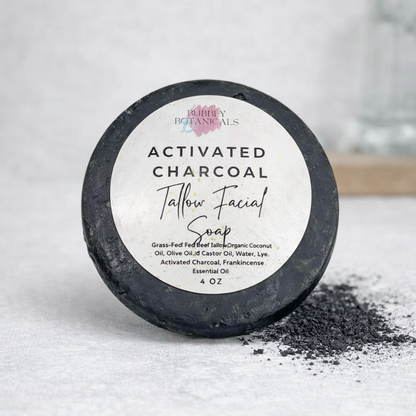 Activated charcoal tallow facial soap with a label on a light background