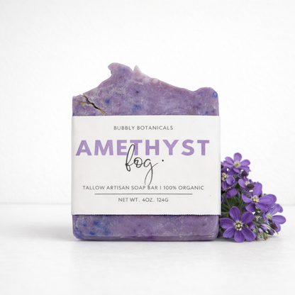 Tallow soap bar with 'Amethyst Fog' label and purple flowers on a white background