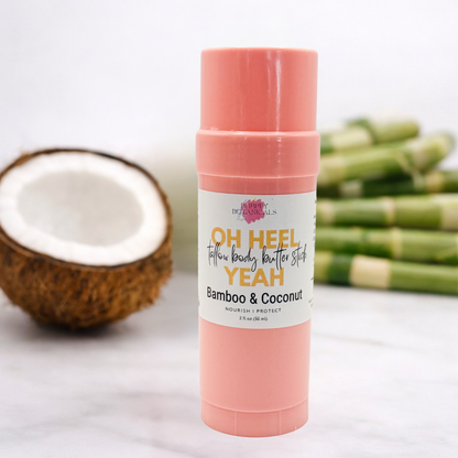 Pink body butter stick with coconut and bamboo elements on a light background