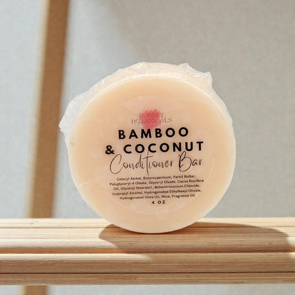 Bamboo & Coconut conditioner bar on a wooden surface with a neutral background