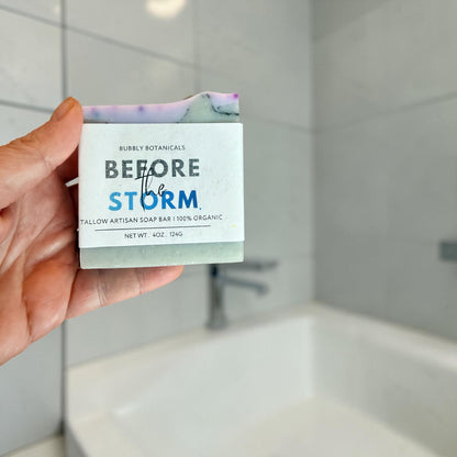 Before the storm tallow soap being held by a hand in the bathroom
