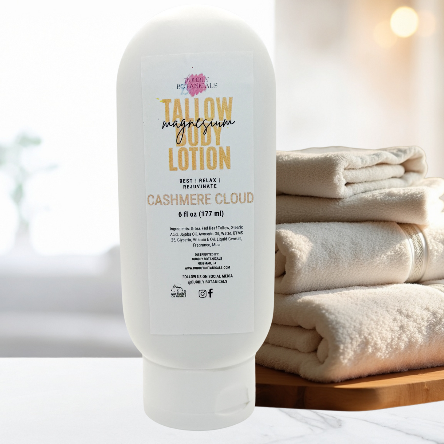 Lotion bottle labeled 'Tallow Magnesium Lotion' with cashmere cloud scent on a bathroom counter.