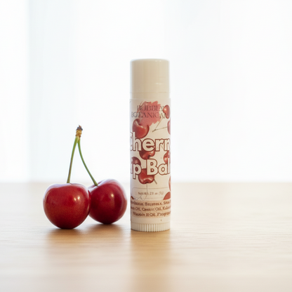 Cherry lip balm with two cherries on a white background