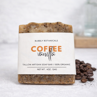 Bar of soap with 'Coffee Vanilla' label and coffee beans on a light background