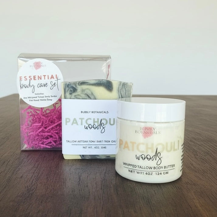 Body care set with body butter, soap, and packaging on a wooden surface