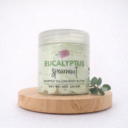 Jar of Eucalyptus Spearmint tallow body butter on a wooden platform with a white background