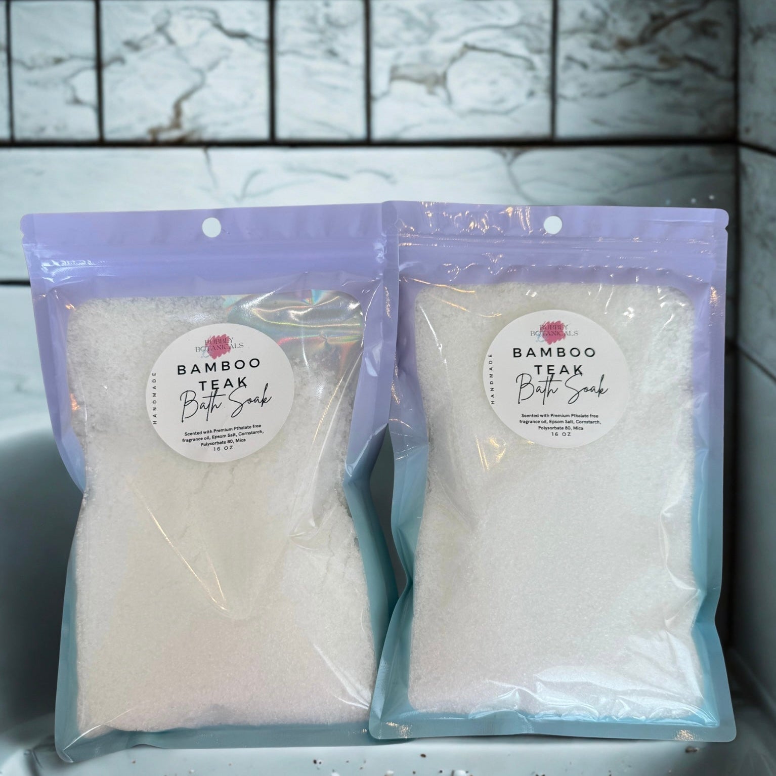 Two packages of Bamboo Teak Butter Soap on a marble countertop.