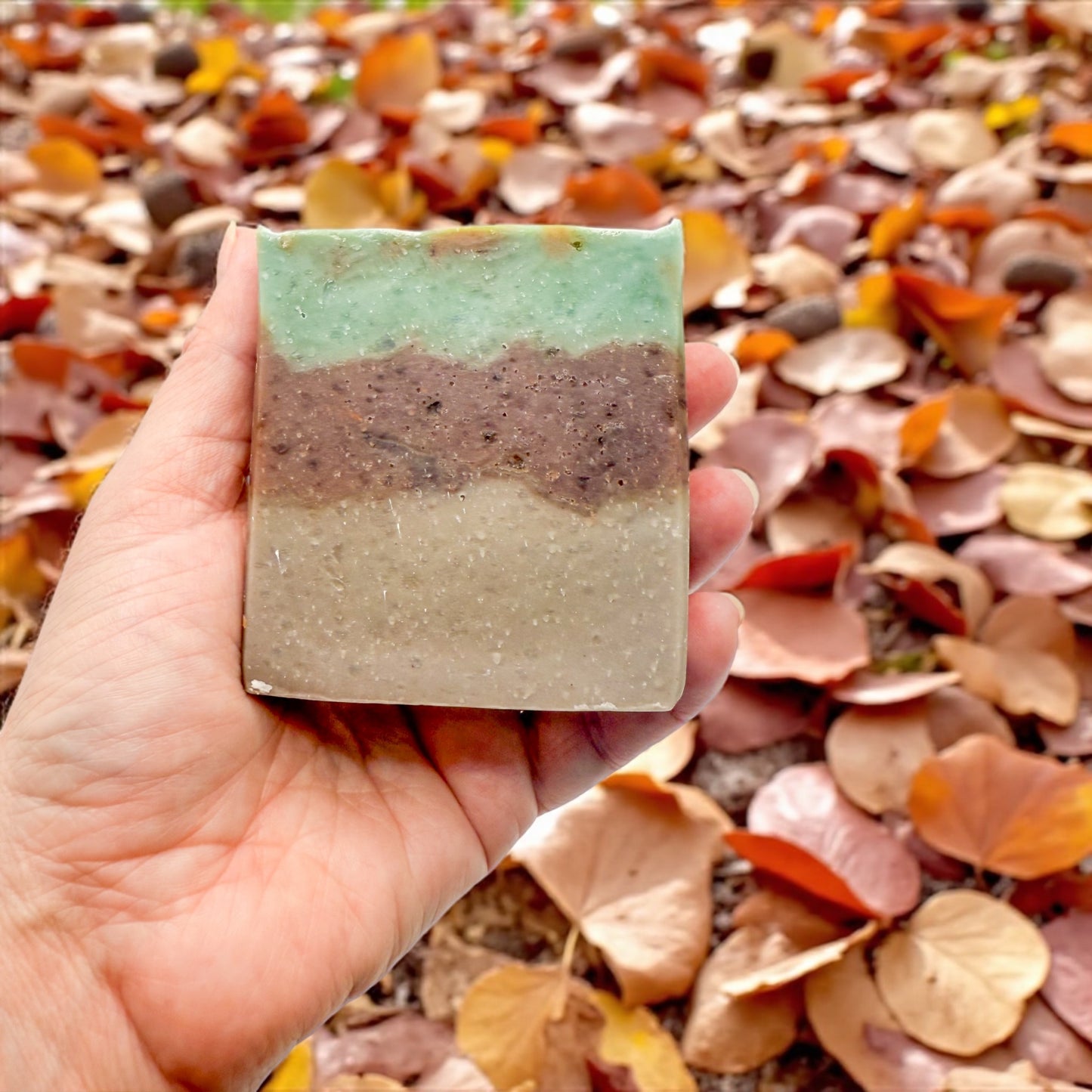 Sweater weather tallow soap with a background of fallen leaves 