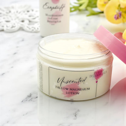 Jar of unscented tallow magnesium lotion with a pink applicator on a marble surface.