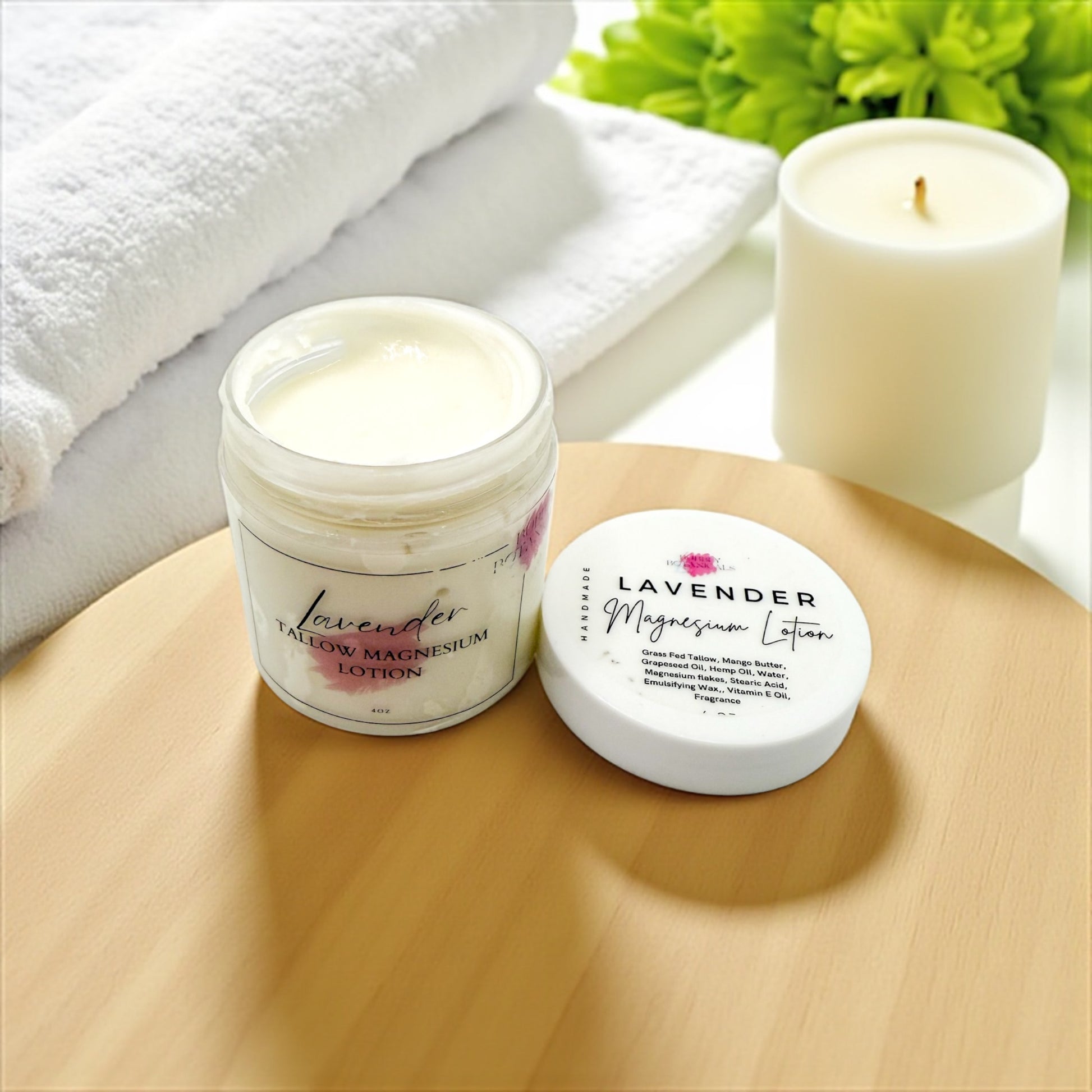 Lavender magnesium lotion jar and container on a wooden surface with a candle and towel in the background.
