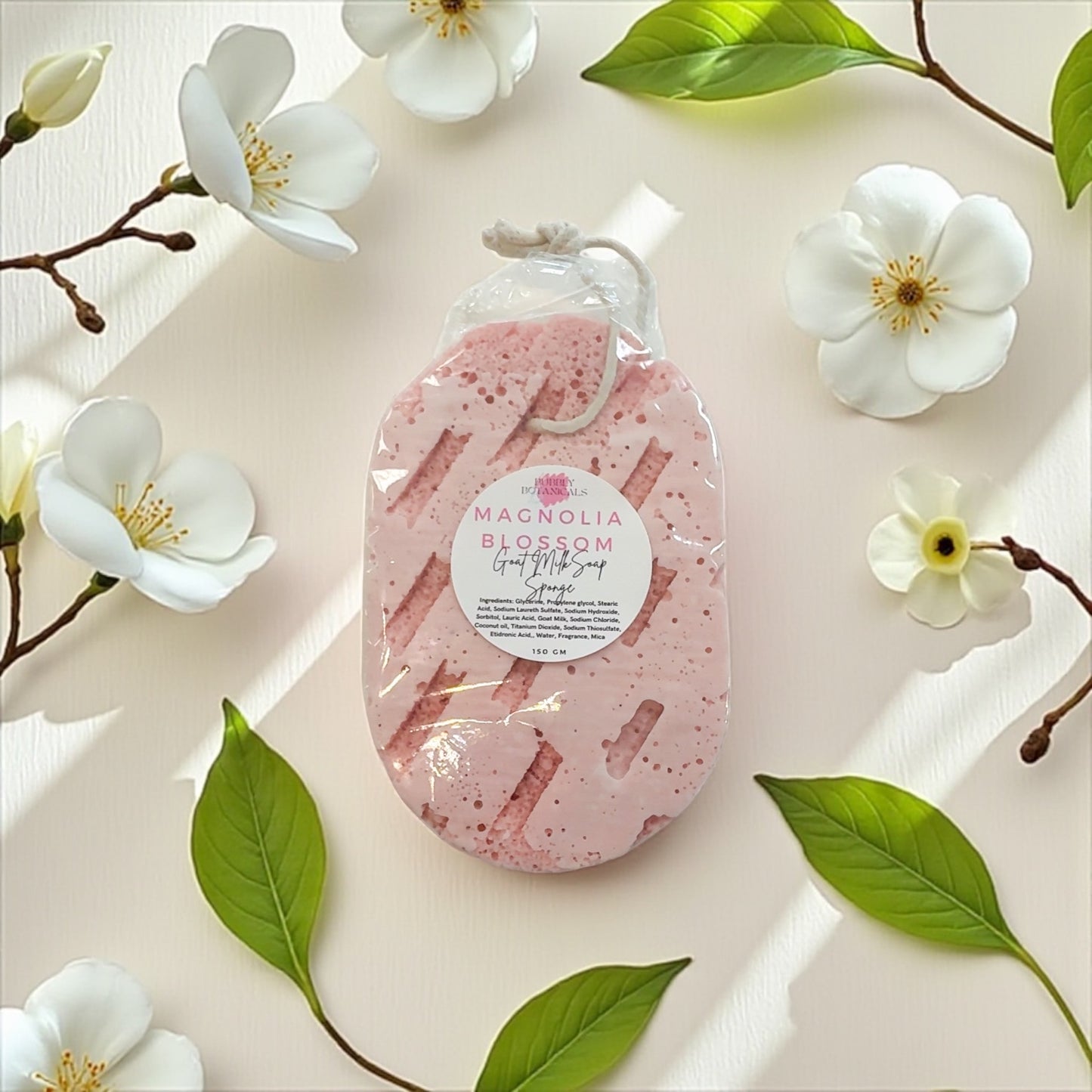 Pink exfoliating pad with a label on a light background with flowers and leaves