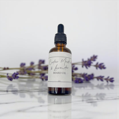 Bottle of Cedar Mist & Lavender beard oil with lavender flowers in the background