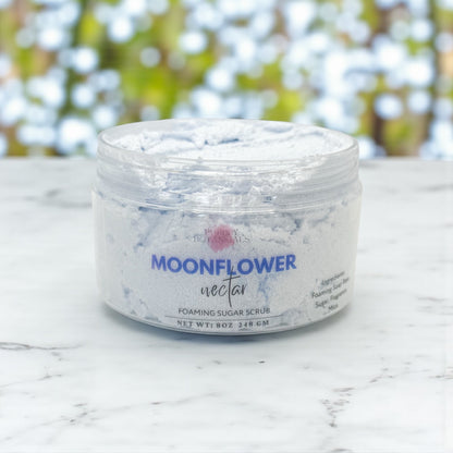 Jar of Moonflower Nectar foaming sugar scrub on a marble surface with a blurred natural background