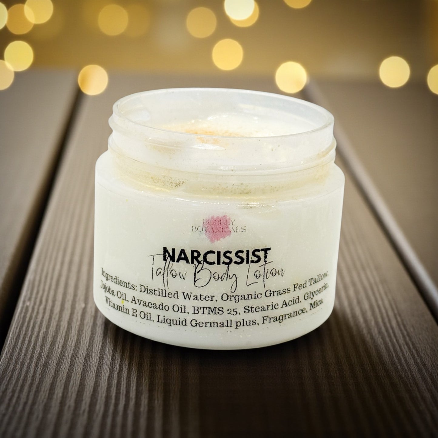 Jar of 'Narcissist' body lotion with a blurred light background