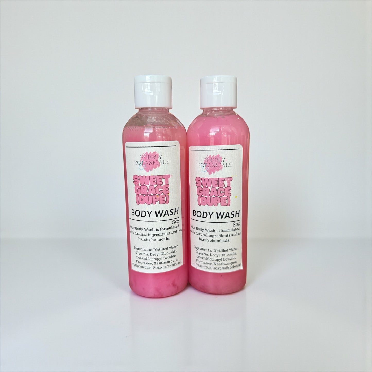 Two bottles of Sweet Grace Body Wash on a white background