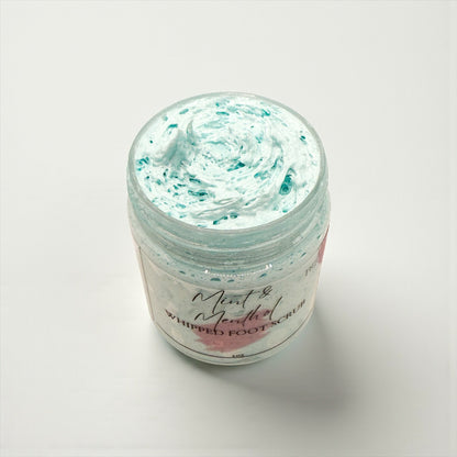 Jar of mint and coconut whipped foot scrub on a white background