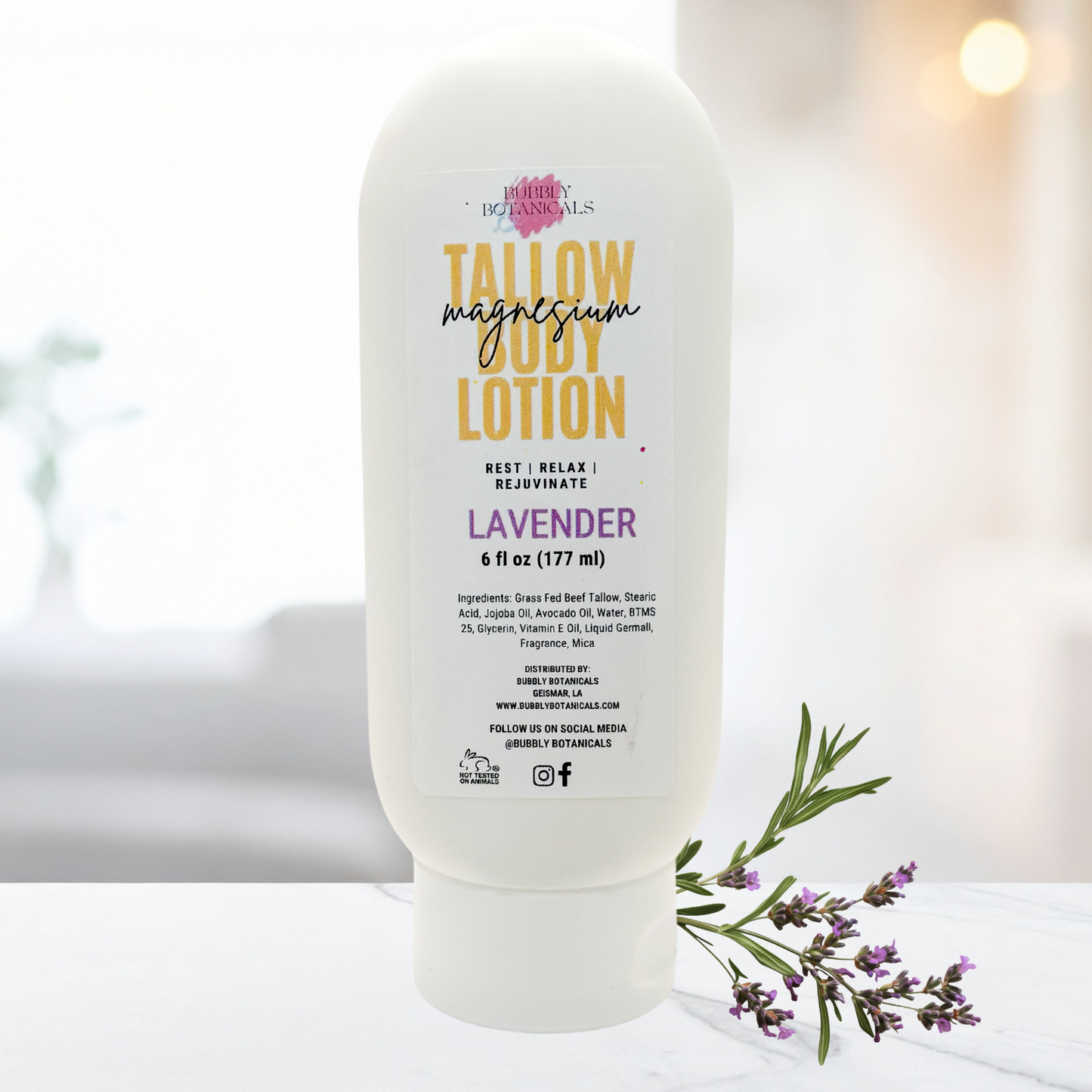 Lotion bottle labeled 'Tallow Magnesium Lavender' on a white surface with lavender flowers.