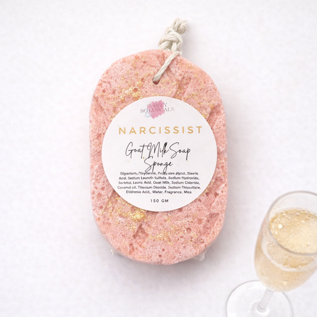 Pink goat milk soap sponge with a label on a white background