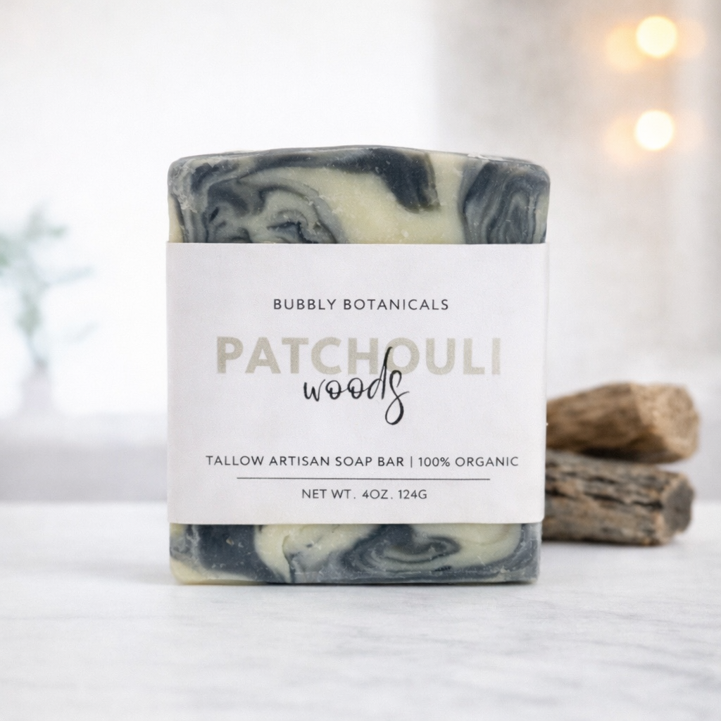Marble-patterned patchouli artisan tallow soap bar with 'Bubbly Botanicals' packaging on a light background