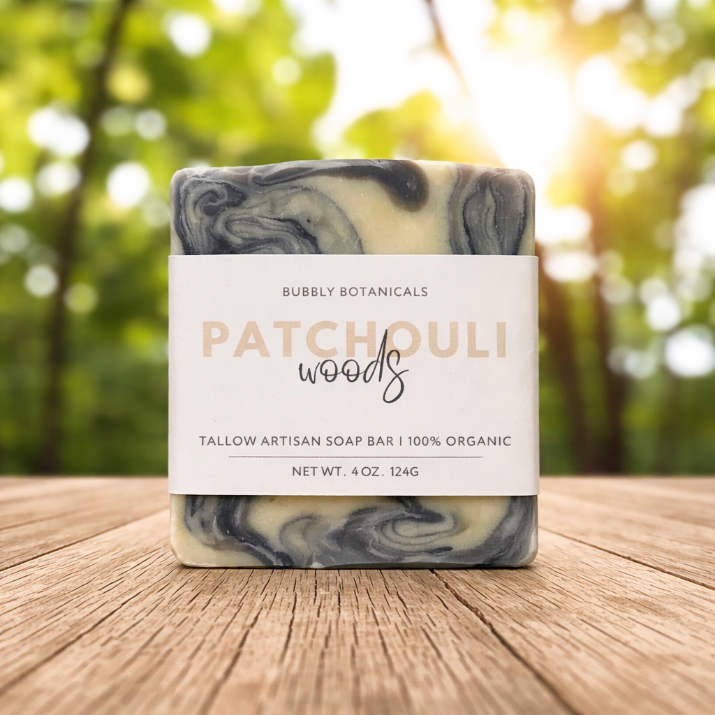Marbled soap bar with 'Patchouli Woods' label on a wooden surface with a blurred natural background