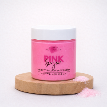 Pink Sugar scented tallow body butter jar labeled 'Pink Sugar' on a wooden platform with a white background