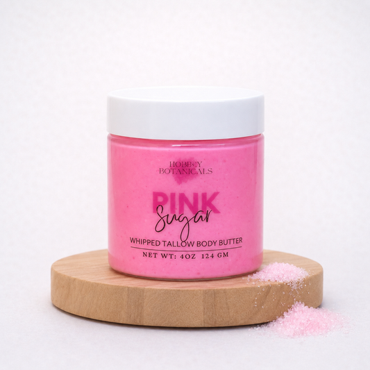 Pink Sugar scented tallow body butter jar labeled 'Pink Sugar' on a wooden platform with a white background
