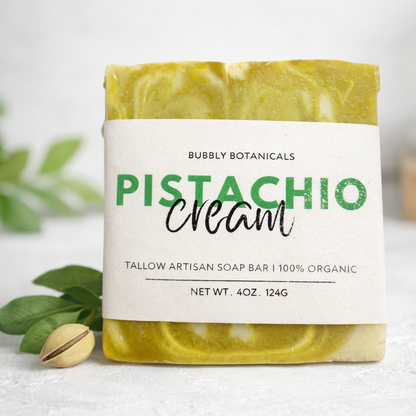 Bar of soap with a label reading 'Pistachio Cream' from Bubbly Botanicals on a light background.