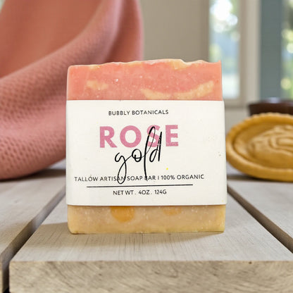 Bar of soap with a 'Bubbly Botanicals Rose Gold' label on a wooden surface.