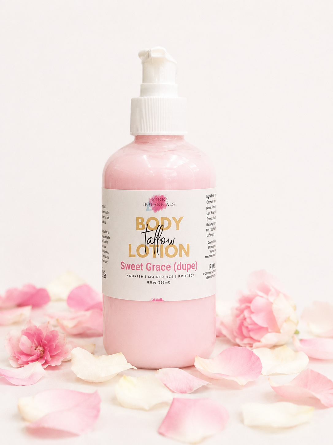 Sweet Grace grass=fed tallow Body lotion bottle with pink label on a white background with pink flowers.