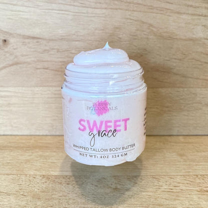 Jar of sweet grace artisan tallow body butter on a wood countertop 