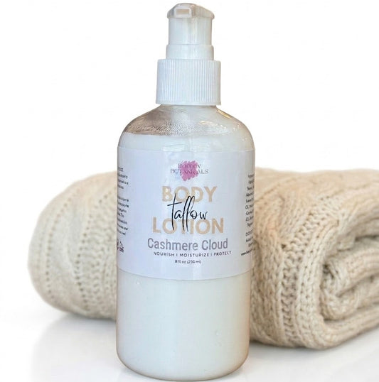 A bottle of Body Tallow Lotion in the 'Cashmere Cloud' scent, shown with a rolled beige knit towel behind it on a white background.