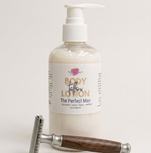 A bottle of the perfect man body tallow lotion with a white pump dispenser and a white label, shown on a light neutral background with a metal-and-wood safety razor placed in front.