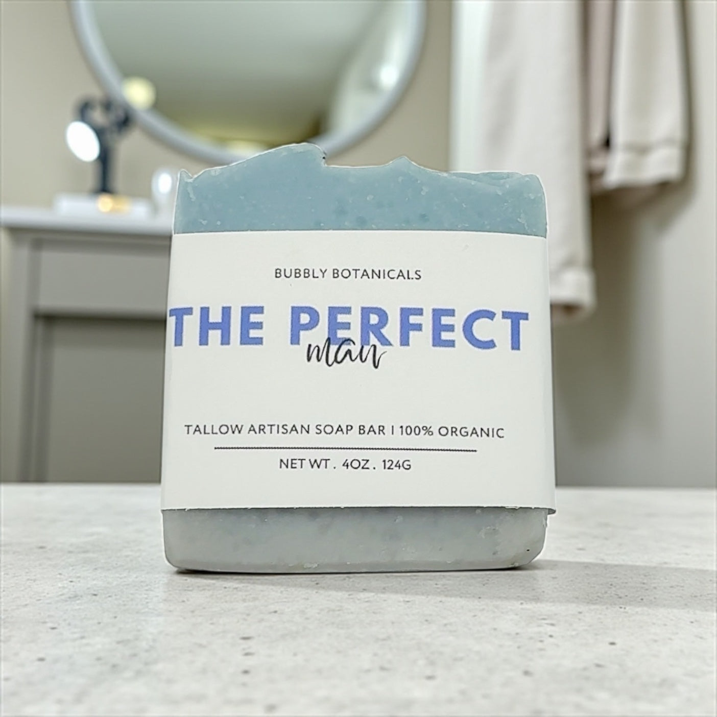 Bar of The perfect man tallow soap for men with a label on a bathroom counter