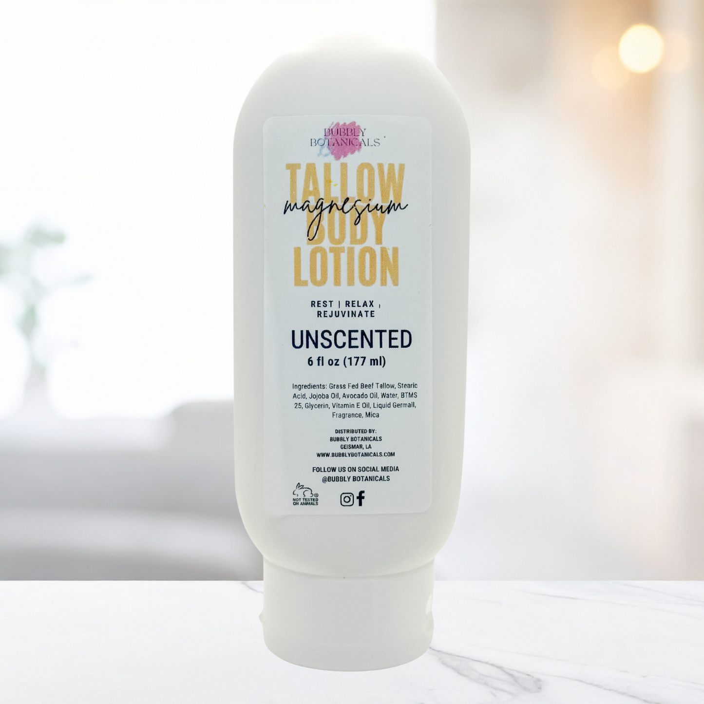 Bottle of tallow magnesia body lotion on a marble surface with a blurred background
