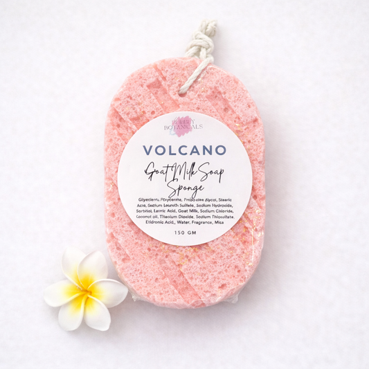 Pink volcano scented goat milk soap sponge with a label on a white background