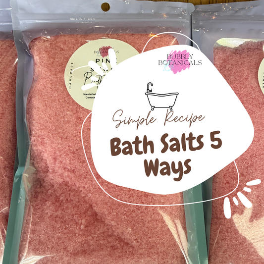 Packaged bath salts with a label indicating 'Simple Recipe Bath Salts 5 Ways' on a wooden surface.
