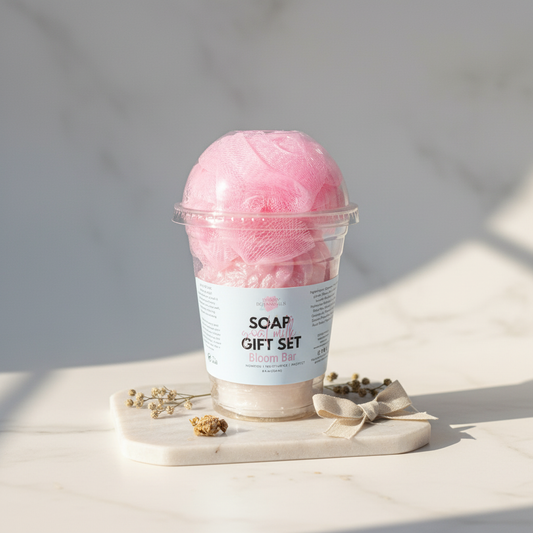 Pink bath bomb in a clear container with a label on a light surface.
