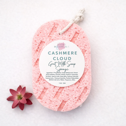 Pink cashmere cloud goat milk soap sponge with a label on a white background