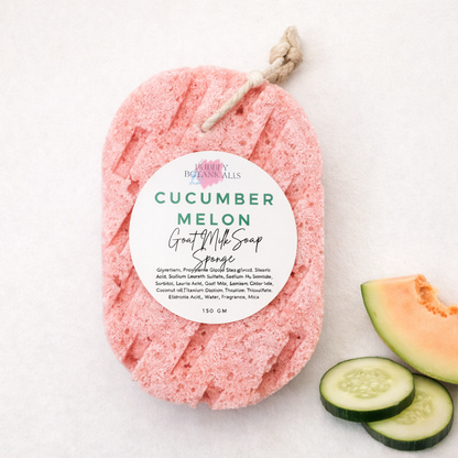 cucumeber melon goat milk soap sponge with a label, cucumber slices, and a piece of cantaloupe on a light background