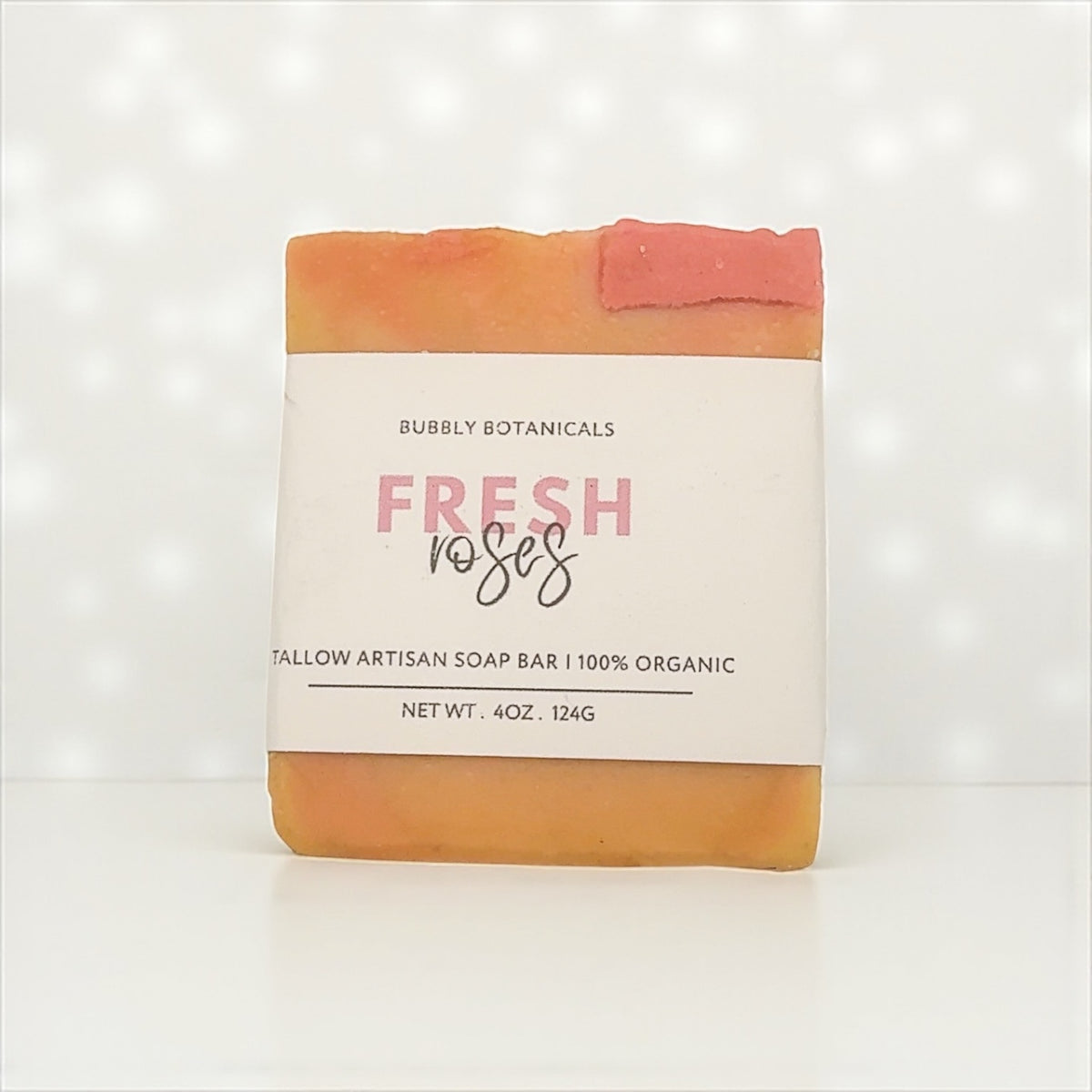 Fresh Roses tallow soap by Bubbly Botanicals with its label on a white background